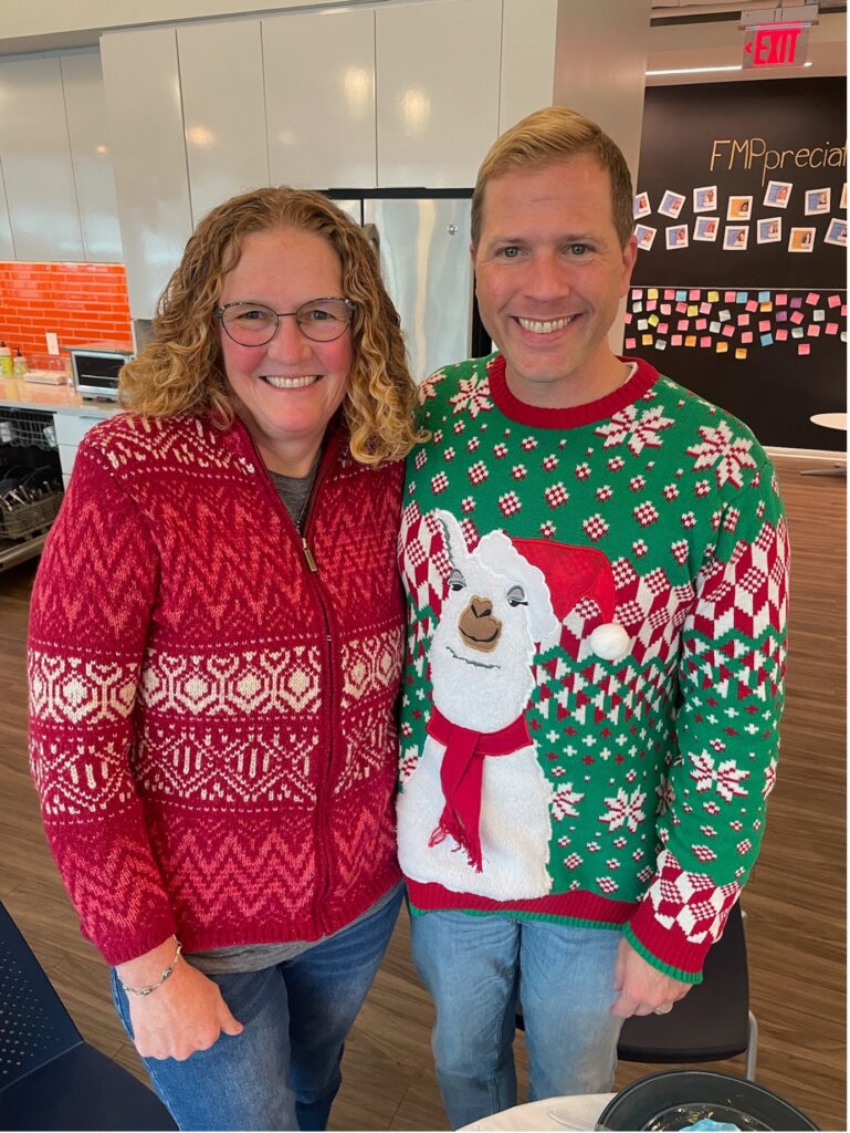 Carolyn and Jacob Flinck wearing festive sweaters in the FMP Office