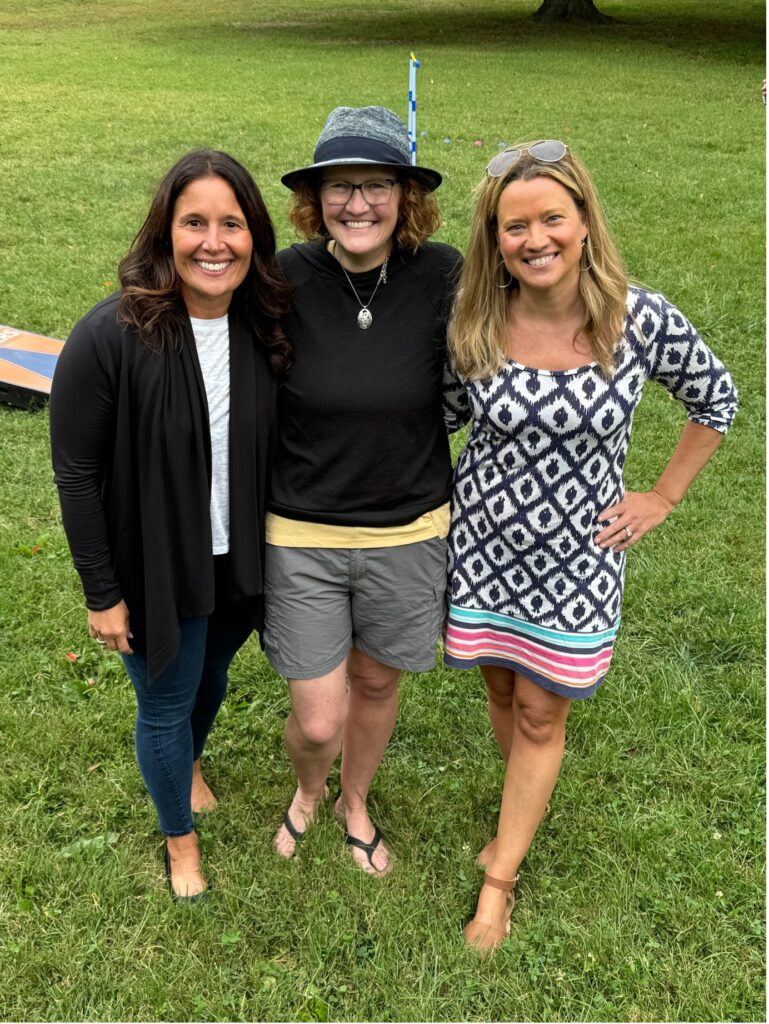 Sherean Miller, Carolyn Kurowski, and Erin Pitera in a park. 