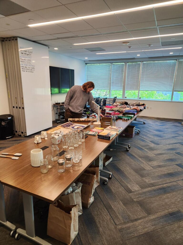 A person looking through items on tables at FMP's Secondhand Market.