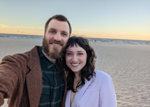 Two people standing on a beach